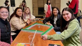 Students at an event playing Mahjong
