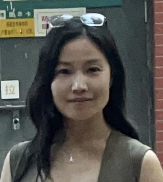 Woman standing in front of a green door