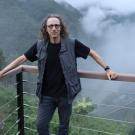 Dr. Foster in front of a foggy mountain