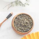 A bowl of tea leaves on a white background