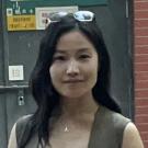 Woman standing in front of a green door